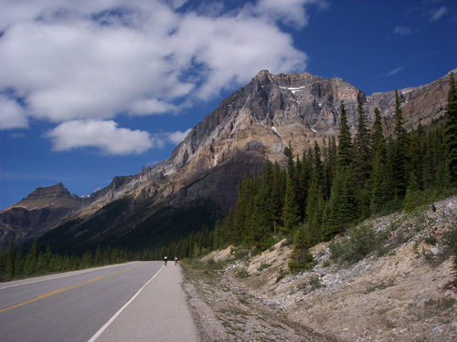 Libby and Tess riding next to mountains in Canada