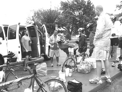 Bike riders do limbo at a rest stop