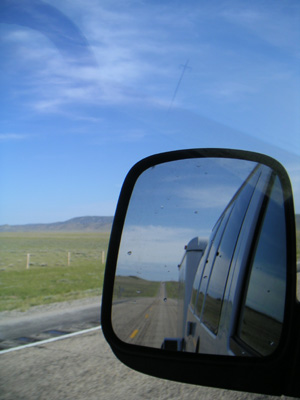 Reflection of the van and trailer in the rear view mirror